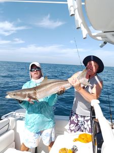Two people fishing on boat in Sarasota