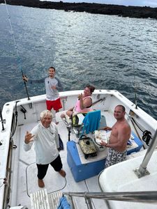4 people enjoying fishing trip in hawaii