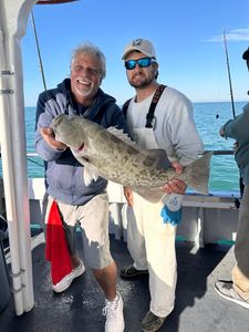 A couple fishing for a gag grouper at St. Pete Beach