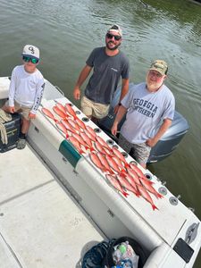 Three anglers fishing from boat in FL