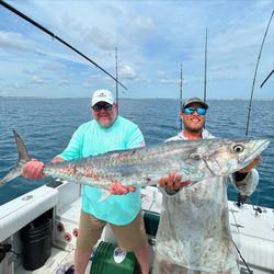 Two people fishing from a boat at New Smyrna Beach