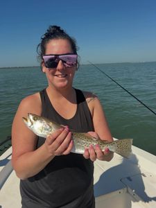 Angler holding caught fish on boat in Fort Myers FL waters