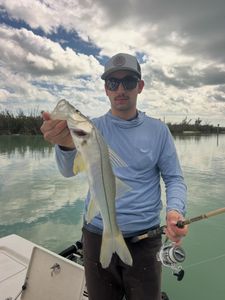 Angler holding caught snook fish on boat in Fort Myers FL waters