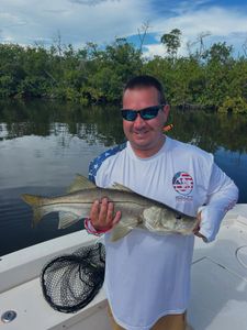 A person fishing for a snook in FL