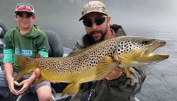 Angler holding a large Atlantic Salmon fish in Keystone
