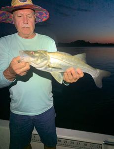 A lone angler reeling in a big catch at New Smyrna Beach