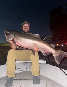 A fisherman catches a lake trout in CA