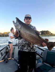 A photo of two people fishing for a rainbow trout in CA