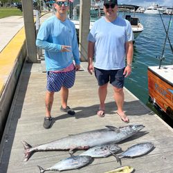Two fishermen with 2 large wahoo fish and little tunny in FL
