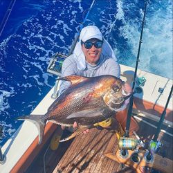 A lone fisherman reeling in a catch in Miami