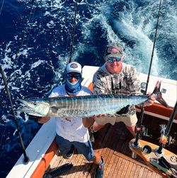Two people fishing for a wahoo fish in Florida