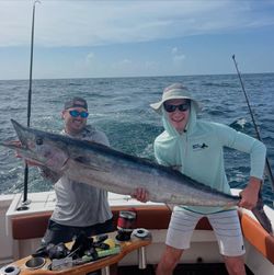 Two people fishing for a wahoo fish in Miami