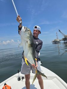A single angler fishing from a boat in Dauphin Island