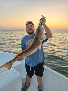 A single angler fishing on the waters of Dauphin Island