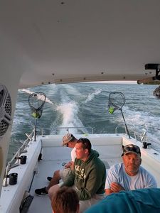 Fishing boat wake on water in Port Clinton OH with fishing equipment visible