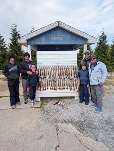 Fishing group displays catch of multiple fish on cleaning station in Port Clinton OH