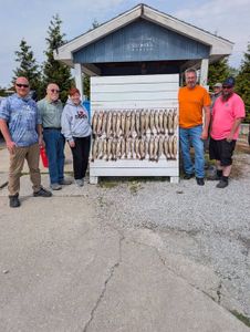 Fishing group displaying large catch of fish at cleaning station in Port Clinton OH