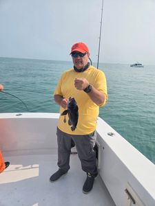 Fisherman with 9-inch sea bass catch in Belmar