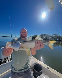 A person fishing with a rod in FL