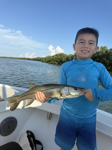 Snook on the line with storm clouds brewing!