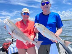 Two redfish, 24 inches long, caught while fishing in FL