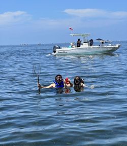 Scallop diving in Homosassa FL with divers in water holding collection nets near fishing boat