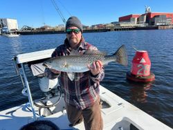 A fisherman with a spotted weakfish, caught in VA