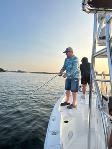 Person casting fishing rod in Rock Hall