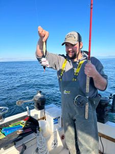 A person standing in Nanaimo, enjoying the best of fishing.