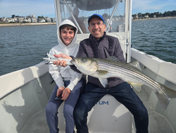 Nice striped bass caught using deep sea jigging techniques in partly cloudy conditions.