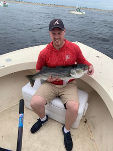 A person fishing for a striped bass in Newburyport