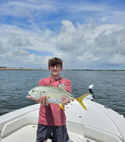 A fisherman catching a Crevalle Jack in Jacksonville
