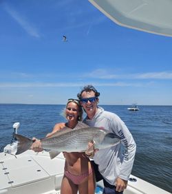 Angler holding a redfish caught while fishing in Florida