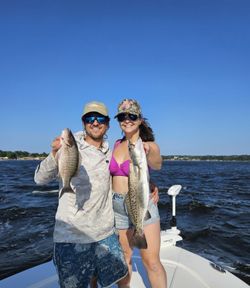 Two anglers with their caught spotted weakfish and grey snapper in Florida