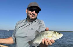 A person fishing for a white bass in Pottsboro