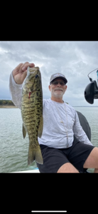 A person fishing in Cleburne, Texas with their catch