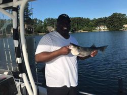 Angler holding a 14-inch fish while fishing in SC