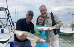 Three people fishing in Port Isabel