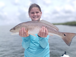 Huge redfish reeled in during a partly cloudy day in Weeki Wachee!