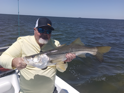 Enjoying a peaceful day on the water reeling in the catch of the day.