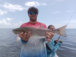 Stormy skies can't dampen the thrill of redfish action!