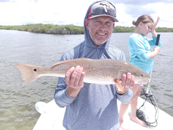 Mastering the art of jigging for redfish in Weeki Wachee's partly cloudy skies!