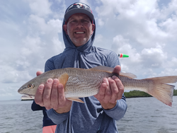 Reeling in reds under stormy skies in Weeki Wachee!
