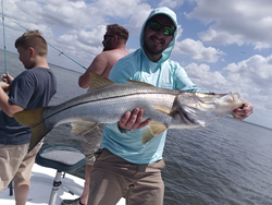 Reeling in a big one on a peaceful day out on the water.