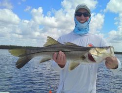 Angler holding large snook fish caught while fishing in Weeki Wachee Florida waters
