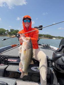 Bass fishing catch on boat in Fort Worth TX lake with fishing rod and tackle