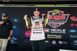 Bass fishing tournament weigh-in showing two large bass being held up at Fort Worth TX competition