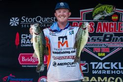 Two spotted bass held up at fishing tournament in Fort Worth TX with sponsor backdrop