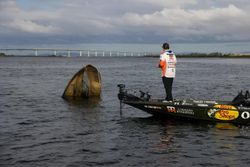Bass fishing boat on lake with partially submerged structure in Fort Worth TX