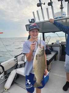 Angler holding a large rainbow trout in Pulaski